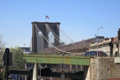 The Brooklyn Bridge rises majestically in the background...