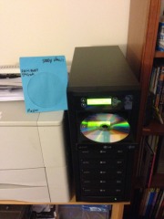 Loading the master DVD into the DVD duplicator to be captured on