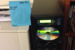Loading the master DVD into the DVD duplicator to be captured on