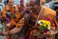 These purple flowers look familiar (sadly, still had the 2x teleconverter on the lens so I couldn't capture the young girl handing them to the monk)...